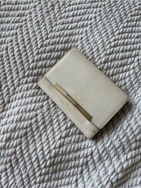 kate spade cream leather bifold wallet with gold bar detail